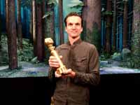 Micah Henrie holding the Golden Globe for Missing Link